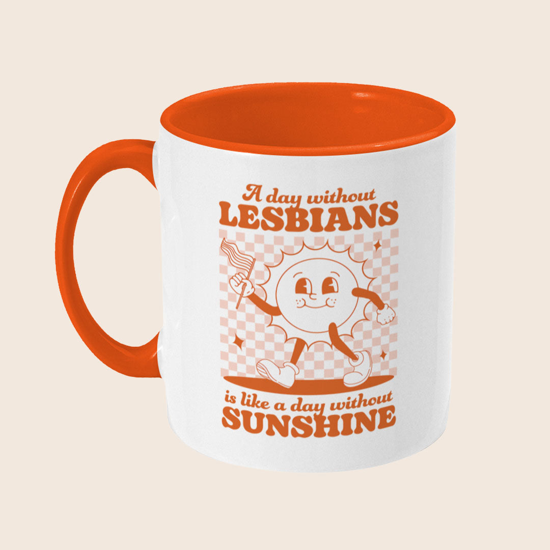 White ceramic mug with an orange interior and handle. The side view shows part of the retro orange checkerboard design and partial lettering of the phrase "A day without LESBIANS is like a day without SUNSHINE."