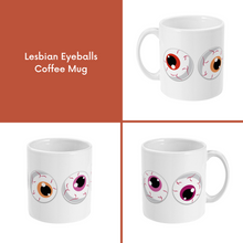 Load image into Gallery viewer, A composite image of a white coffee mug with a cartoon eyeball design in lesbian pride flag colours.