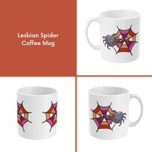 Load image into Gallery viewer, A composite image of a white coffee mug with a cartoon spider and spider web design in lesbian pride flag colours. 