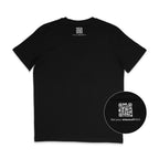 Back of a black t-shirt featuring a small white QR code printed just below the neckline, with the text “Get your #MeAndTshirt” underneath. A circular zoom-in highlights the QR detail.
