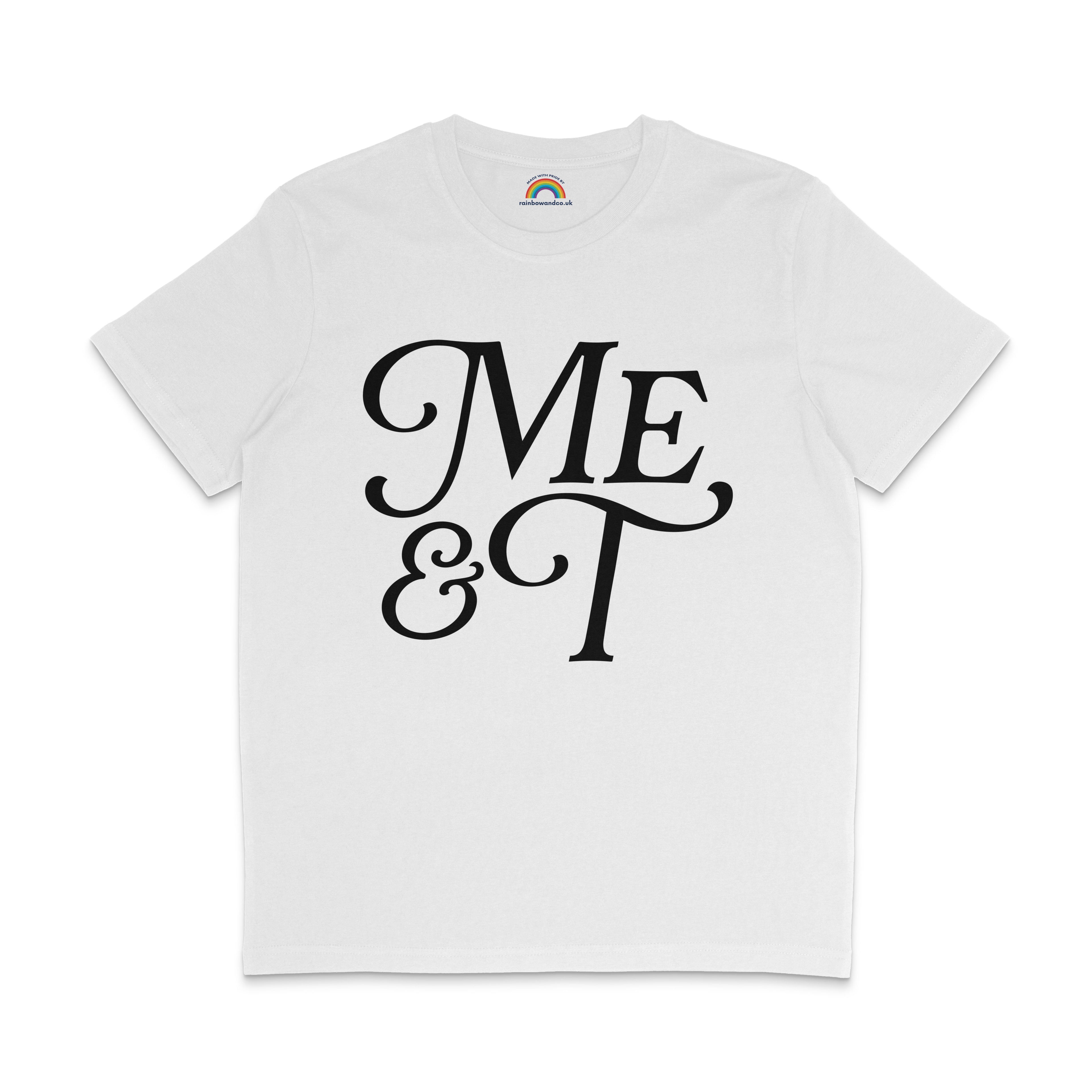 Flat lay of a white t-shirt with bold black text reading “Me & T” in a decorative serif font. The inside neckline features a rainbow logo with the website rainbowandco.uk.
