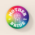 38mm Mother of the Bride badge with rainbow gradient background, white retro lettering and champagne glass illustration.