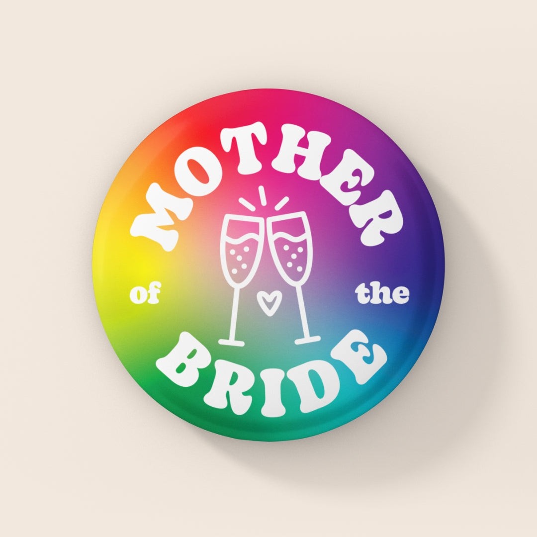38mm Mother of the Bride badge with rainbow gradient background, white retro lettering and champagne glass illustration.
