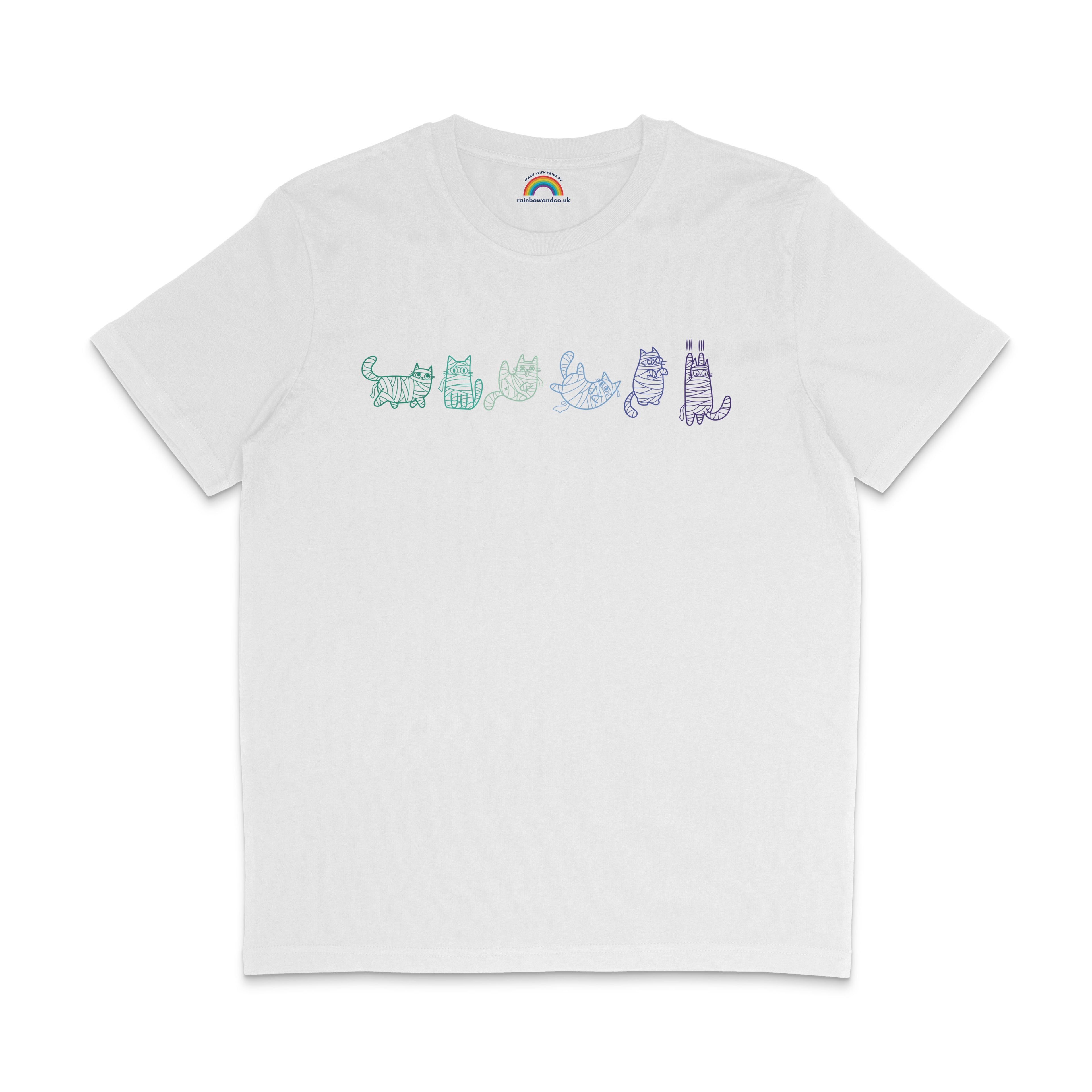 A white T-shirt displaying six mummy cat illustrations in the colours of the gay pride flag. Each cat is wrapped in bandages and has a different pose and expression, with the designs drawn in shades of green, teal, blue, and purple.