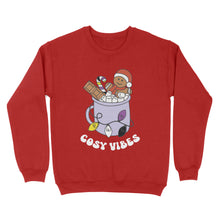 Load image into Gallery viewer, Fire Red sweatshirt featuring retro text reading &#39;cosy vibes&#39;. The image shows a mug of hot chocolate with marshmallows and a gingerbread man wearing a Santa hat. A candy cane in the mug and lights around the mug are the colours of the non binary pride flag.