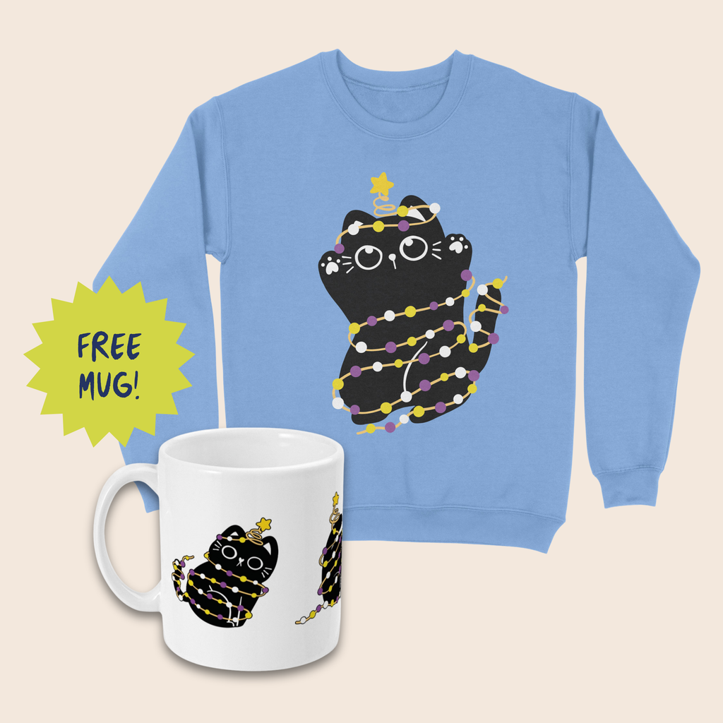 Light blue Christmas jumper and matching white mug featuring black cats wrapped in yellow, white and purple fairy lights, with yellow stars above their heads, arranged on a cream background. A lime-green starburst beside the mug reads “FREE MUG!”