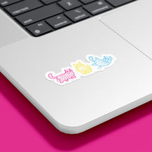 Load image into Gallery viewer, A laptop decorated with mummy-wrapped cat stickers in pink, yellow, and blue, representing the pansexual flag colours.