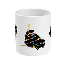 Load image into Gallery viewer, A white ceramic mug featuring an adorable black cat wrapped in colourful festive lights in the colours of the pansexual pride flag (pink, yellow, blue), with a golden star resting on its head, representing a Christmas tree topper.