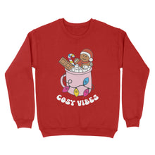 Load image into Gallery viewer, Fire Red sweatshirt featuring retro text reading &#39;cosy vibes&#39;. The image shows a mug of hot chocolate with marshmallows and a gingerbread man wearing a Santa hat. A candy cane in the mug and lights around the mug are the colours of the pansexual pride flag.