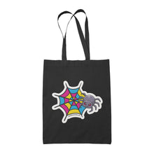 Load image into Gallery viewer, A black tote bag featuring a cute cartoon spider in front of a spider web coloured in the pansexual pride flag colours: pink, yellow, and blue.