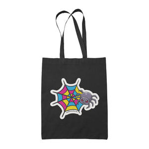 A black tote bag featuring a cute cartoon spider in front of a spider web coloured in the pansexual pride flag colours: pink, yellow, and blue.