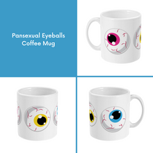 Load image into Gallery viewer, A composite image of a white coffee mug with a cartoon eyeball design in pansexual pride flag colours.