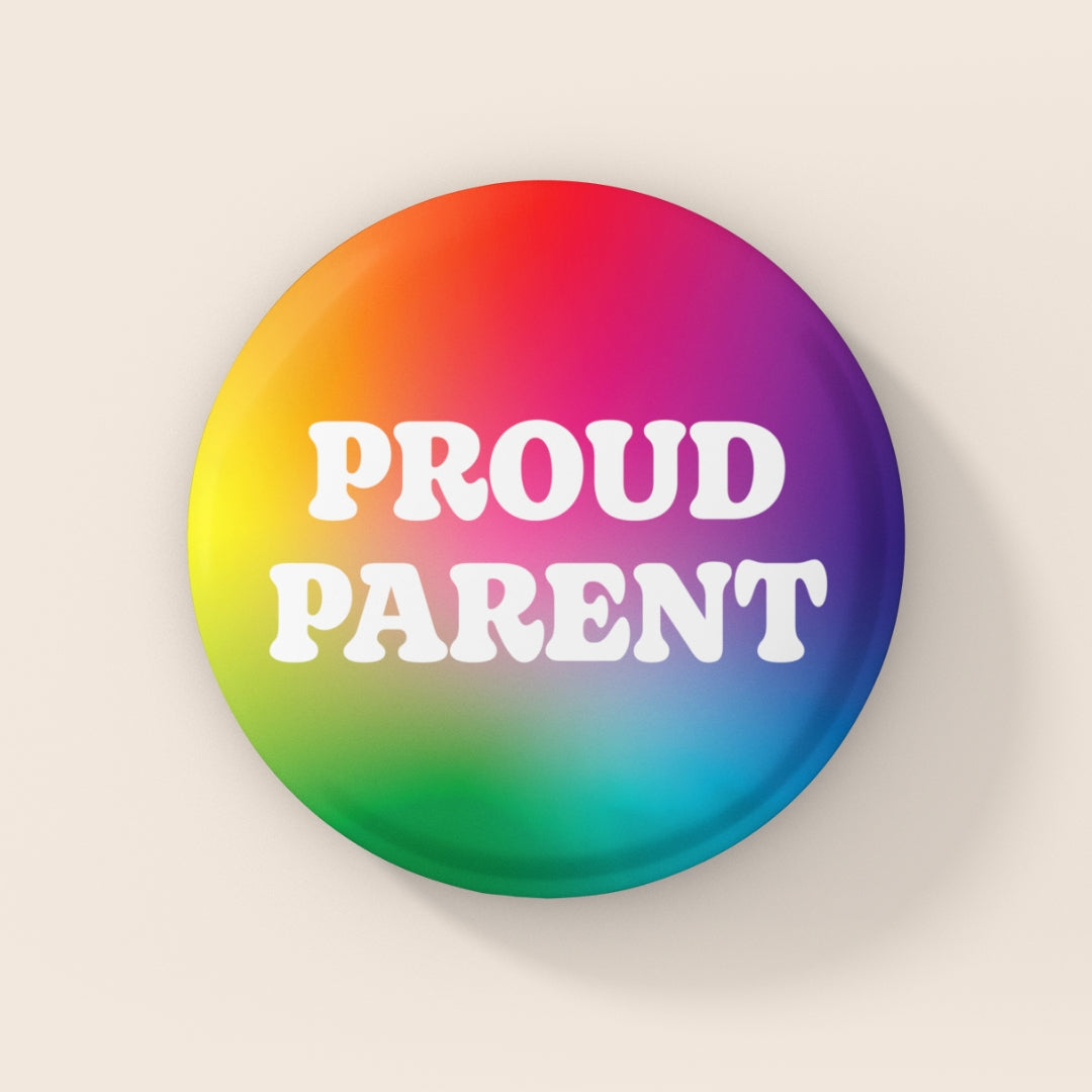 Round 38mm Pride badge with rainbow gradient background and white “PROUD PARENT” text.