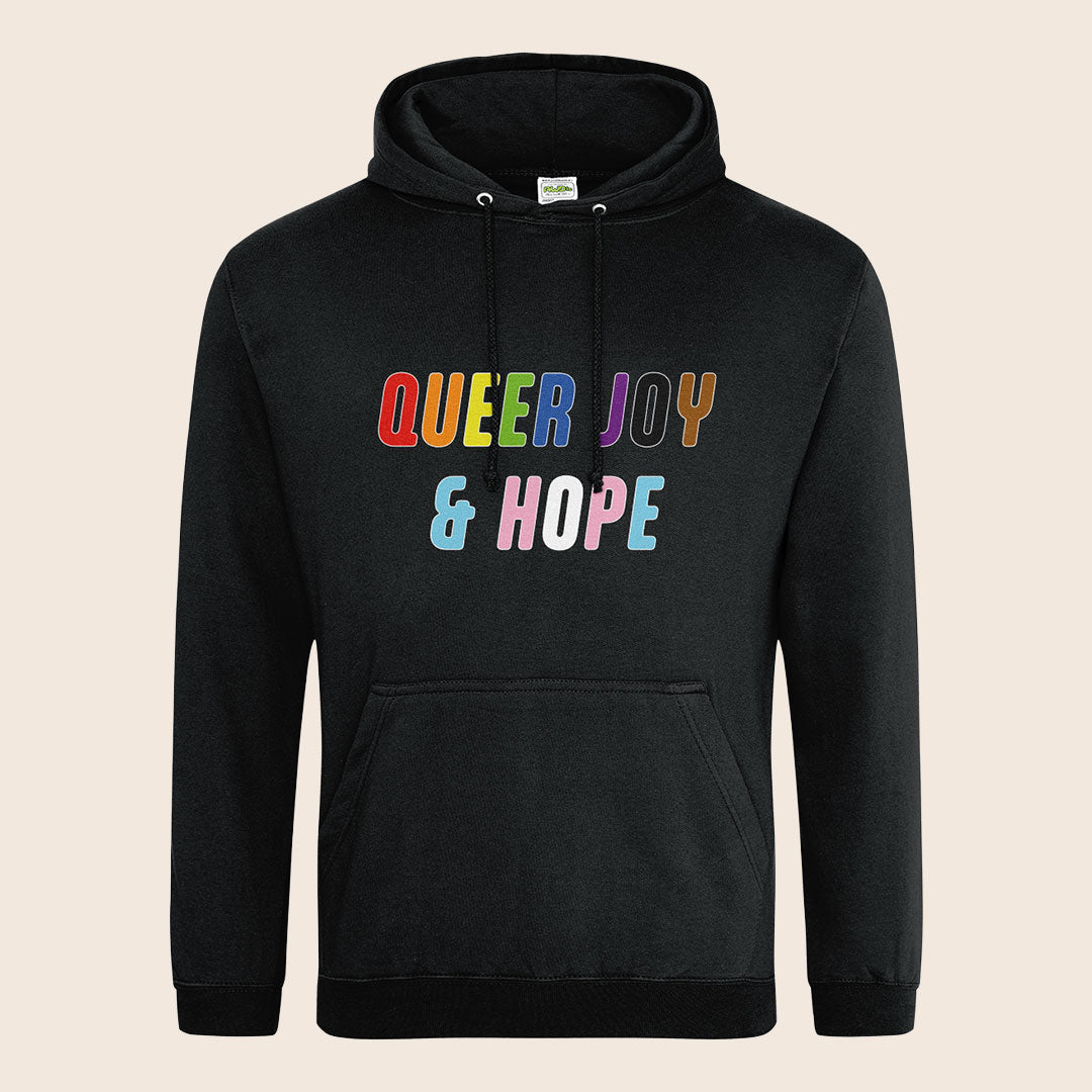 Black pullover hoodie with drawstring hood and kangaroo pocket, featuring colourful “Queer Joy & Hope” text across the chest.