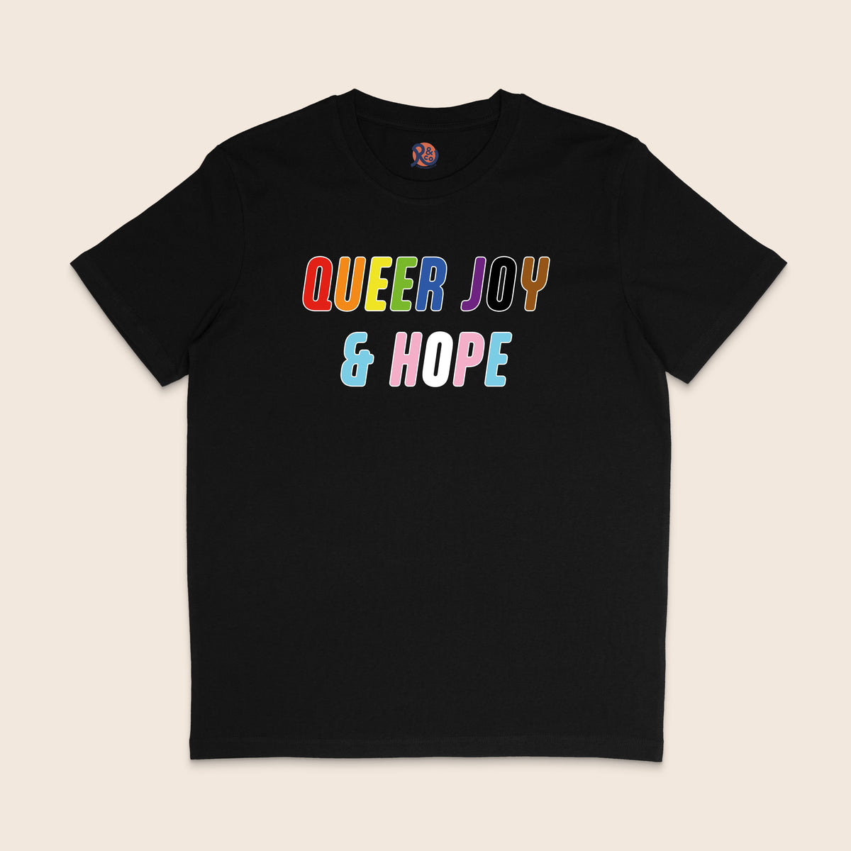 Black T-shirt with colourful text reading “Queer Joy & Hope” across the chest in rainbow and trans Pride-inspired colours.