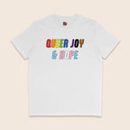 White T-shirt with colourful text reading “Queer Joy & Hope” across the chest in rainbow and trans Pride-inspired colours.