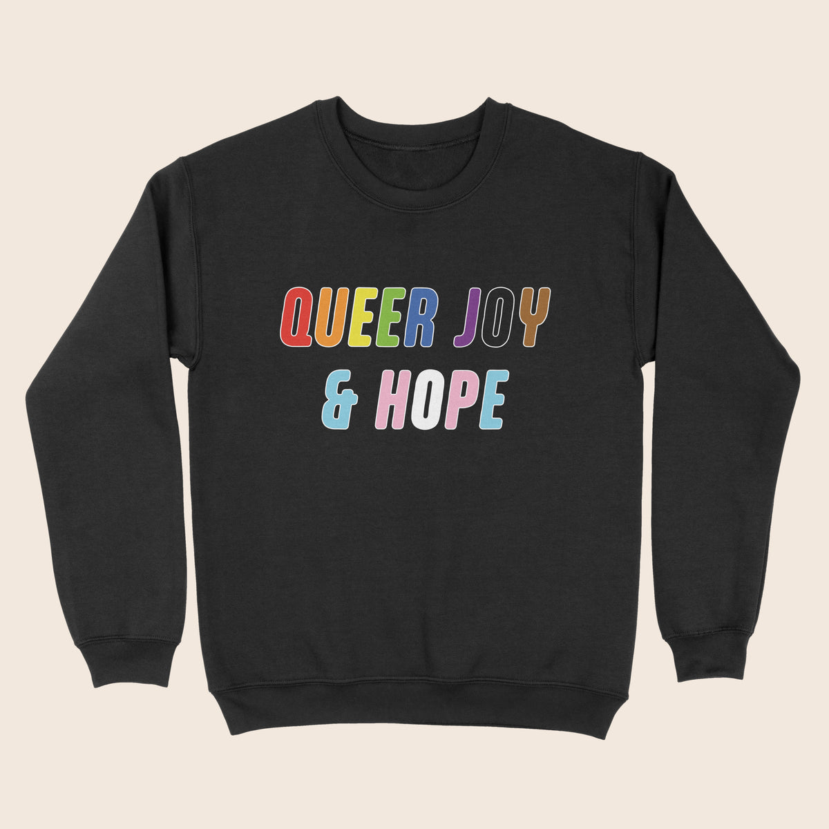 Black sweatshirt with colourful “Queer Joy & Hope” text across the chest in rainbow and trans Pride-inspired colours.