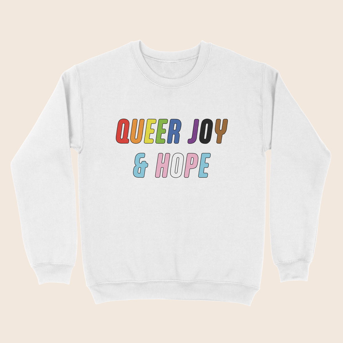 White sweatshirt with colourful “Queer Joy & Hope” text across the chest in rainbow and trans Pride-inspired colours.