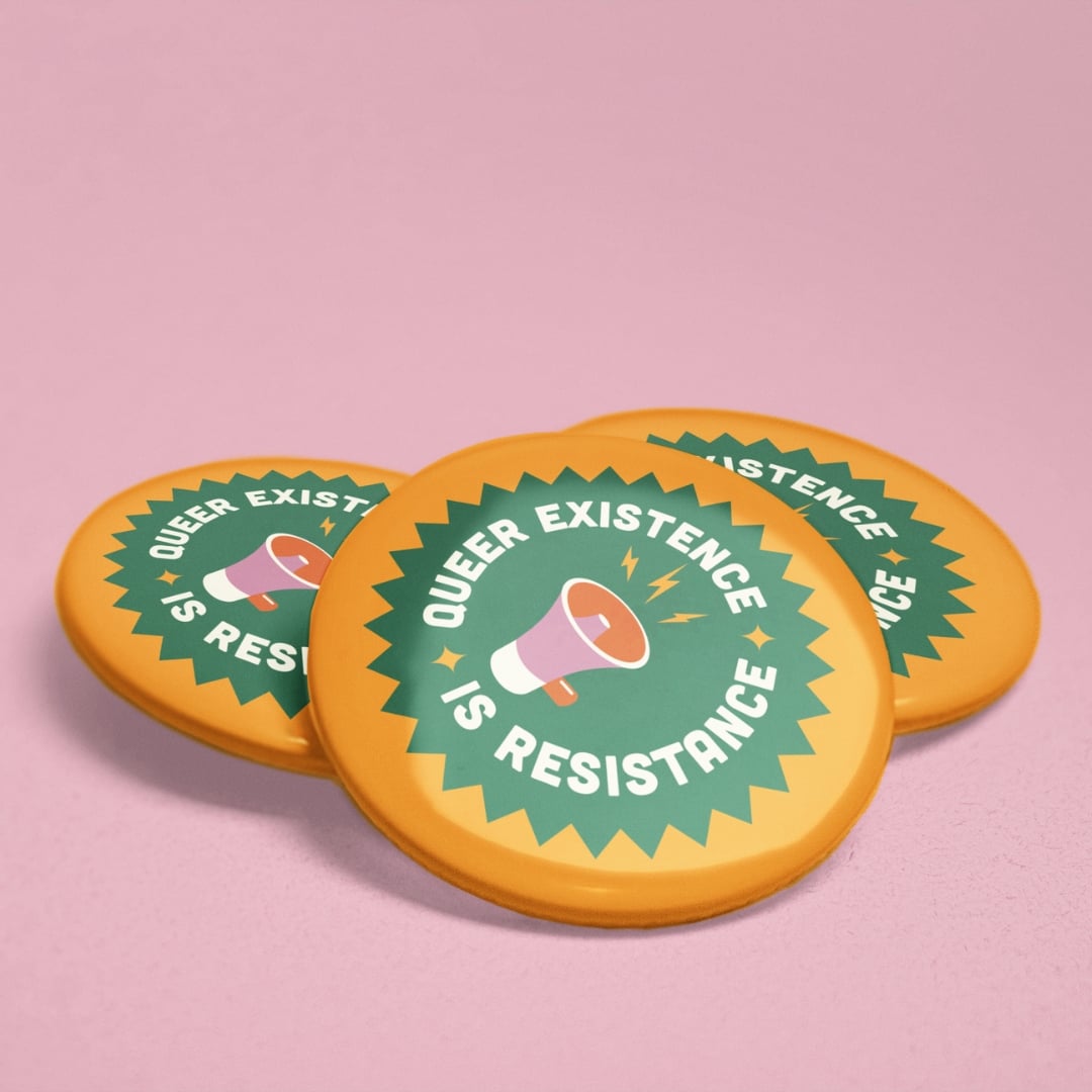 Three 38mm Queer Existence Is Resistance badges stacked on pink background showing glossy finish and bold activist design.