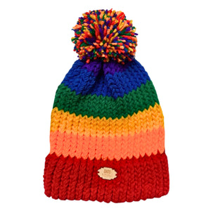 Striped knitted bobble hat in the colours of the rainbow pride flag laying flat.