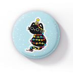 A black cat wrapped in rainbow-coloured string lights, with a star atop its head, sitting playfully on a light blue background with snowflakes.