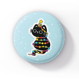 A black cat wrapped in rainbow-coloured string lights, with a star atop its head, sitting playfully on a light blue background with snowflakes.