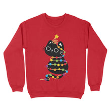 Load image into Gallery viewer, Fire red sweatshirt adorned with a black cat entangled in rainbow-coloured holiday lights, its tail topped with a star.