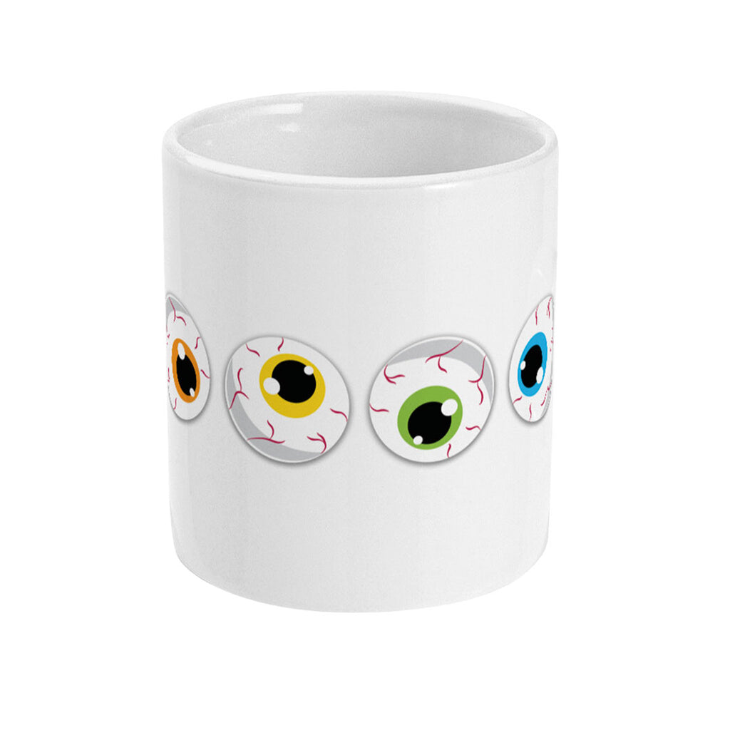 A white ceramic mug with a front view displaying three cartoon eyeballs with irises in different colours—green, blue, and purple. The colours of the irises represent the diversity of the rainbow flag, with red veins adding a quirky, spooky element to the design.
