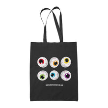 Load image into Gallery viewer, A black tote bag showcasing a collection of six cartoonish eyeballs arranged in two rows. Each eyeball has a unique colour: red, orange, yellow, green, blue, and purple. The text &quot;RAINBOWANDCO.UK&quot; is placed underneath the design, with a banner stating &quot;8 IDENTITIES AVAILABLE&quot;.