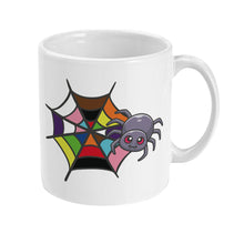 Load image into Gallery viewer, A white ceramic mug from another side angle, showing a cartoon spider with a smiling face and a colourful rainbow spider web. The web is designed with multiple pride colours, creating a bright and festive look.