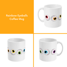 Load image into Gallery viewer, A composite image of a white coffee mug with a cartoon eyeball design in rainbow pride flag colours.