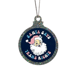 A silver glitter bauble against a white background featuring the text Santa Says Trans Rights and a illustration of Santa Claus. It is held up by a silver string.