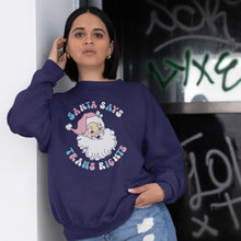 Load image into Gallery viewer, Young woman wearing an Oxford Navy sweatshirt with a Santa Says Trans Rights motif in the colours of the Transgender flag