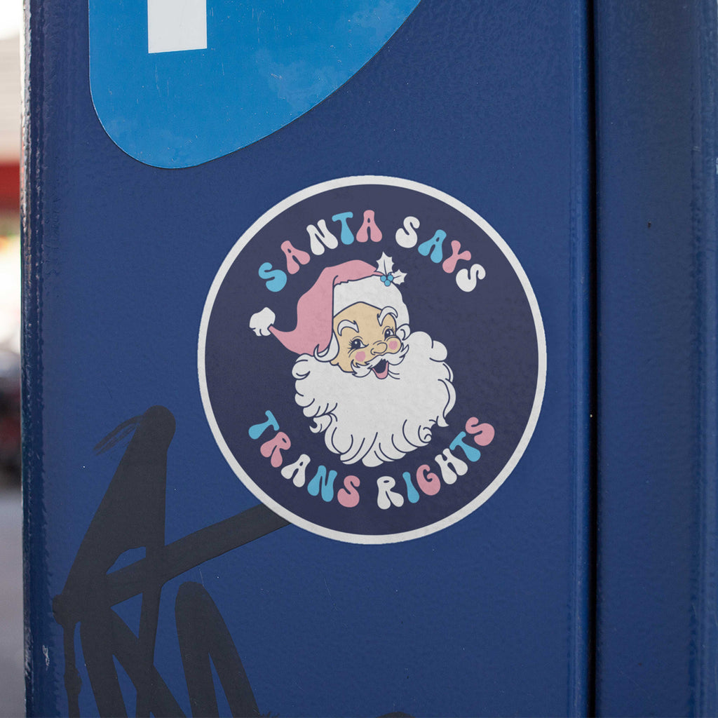 Santa Says Trans Rights Sticker stuck to a blue metal parking metre