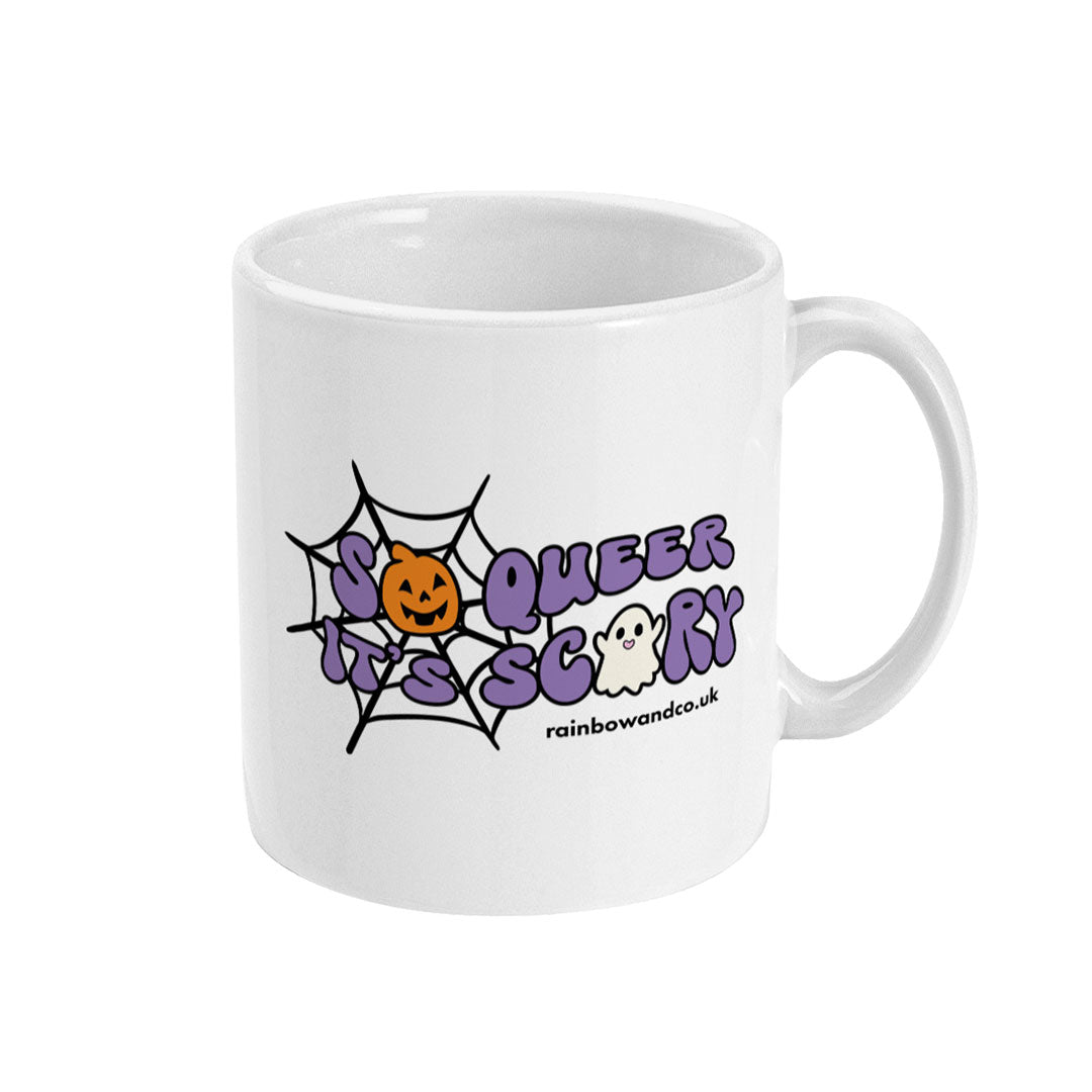 A white ceramic coffee mug with the handle on the right. The mug shows the slogan So Queer It's Scary alongside halloween icons of a pumpkin, ghost, and spiders web