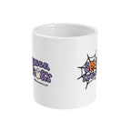 A white ceramic coffee mug with handle facing away from view. The mug shows the slogan So Queer It's Scary alongside halloween icons of a pumpkin, ghost, and spiders web