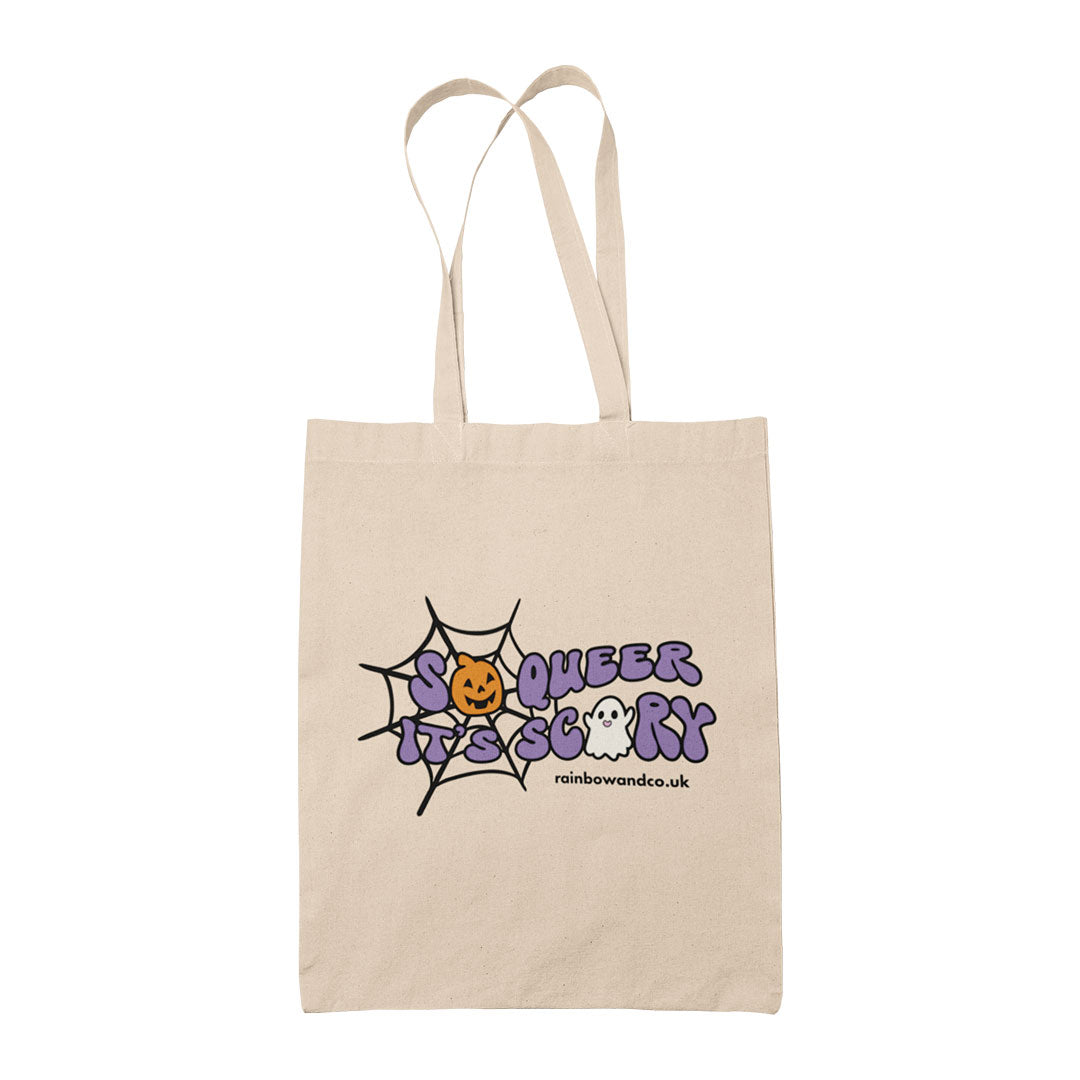 Natural cotton tote bag featuring the slogan So Queer It's Scary alongside halloween icons of a pumpkin, ghost, and spiders web