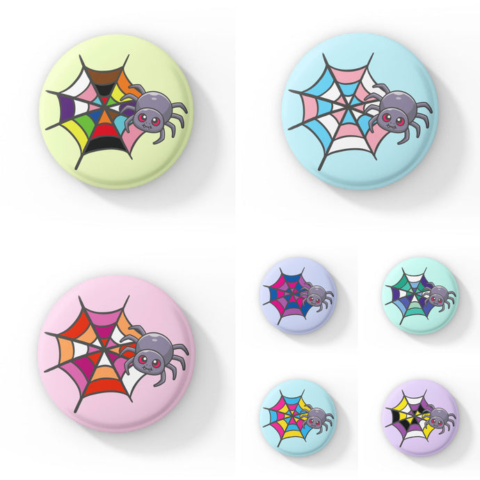 A collection of circular badges, each featuring a cute grey spider with pink eyes on a web coloured in various pride flag colours, including asexual, bisexual, gay, lesbian, non-binary, pansexual, rainbow, and transgender pride flags. Each badge has a different pastel background colour.