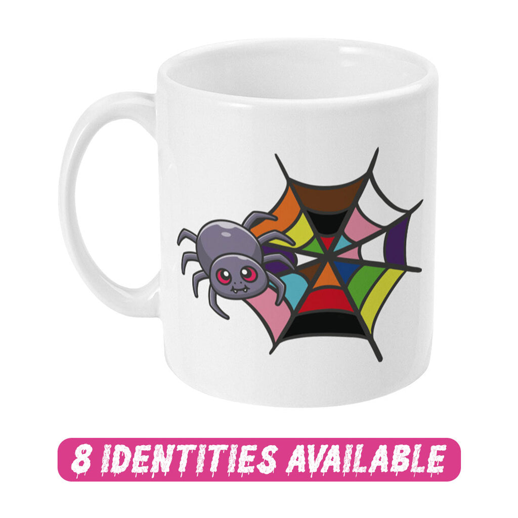 A white ceramic mug featuring a cute cartoon spider next to a colourful spider web that represents the rainbow flag. The text "8 IDENTITIES AVAILABLE" is displayed in bold, dripping pink letters below the mug, highlighting the variety of designs available in this collection.