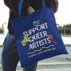Person carrying a royal blue Support Queer Artists tote bag over their shoulder featuring colourful LGBTQ+ inspired artwork and the words "Community Over Corporations".