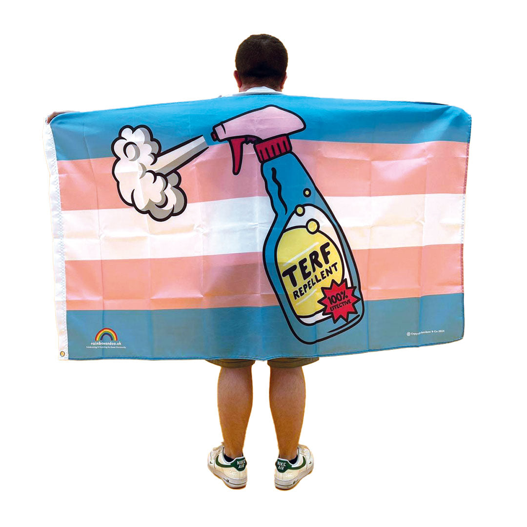 Young man with back to camera wearing a 5ft x 3ft TERF Repellent Flag around his shoulders - Rainbow & Co
