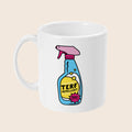 A white ceramic mug is displayed front-on, featuring a single large illustration of a colourful spray bottle with the label “TERF REPELLENT” and a pink starburst that reads “100% EFFECTIVE.” The bottle has a blue body, yellow liquid inside, and a pink nozzle. The background is plain cream.