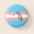 38mm round badge featuring the trans pride flag colours with an illustrated spray bottle labelled “TERF Repellent – 100% Effective” on a blue and pink striped background.