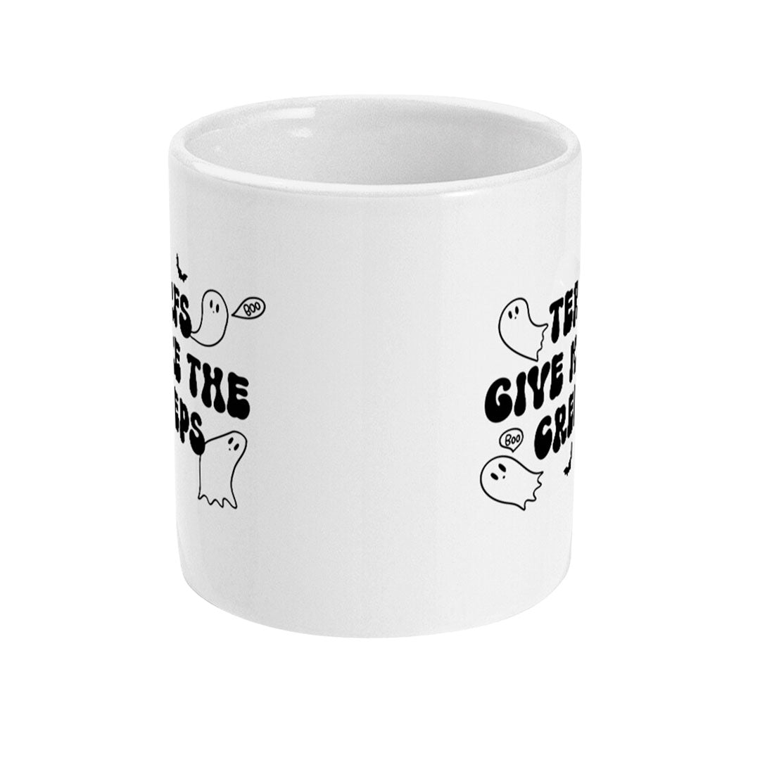 A white ceramic mug with a black and white design showing cartoon ghosts and bats surrounding the text "TERFs Give Me The Creeps." The text is in a bold, horror-inspired font, adding a fun and spooky vibe.