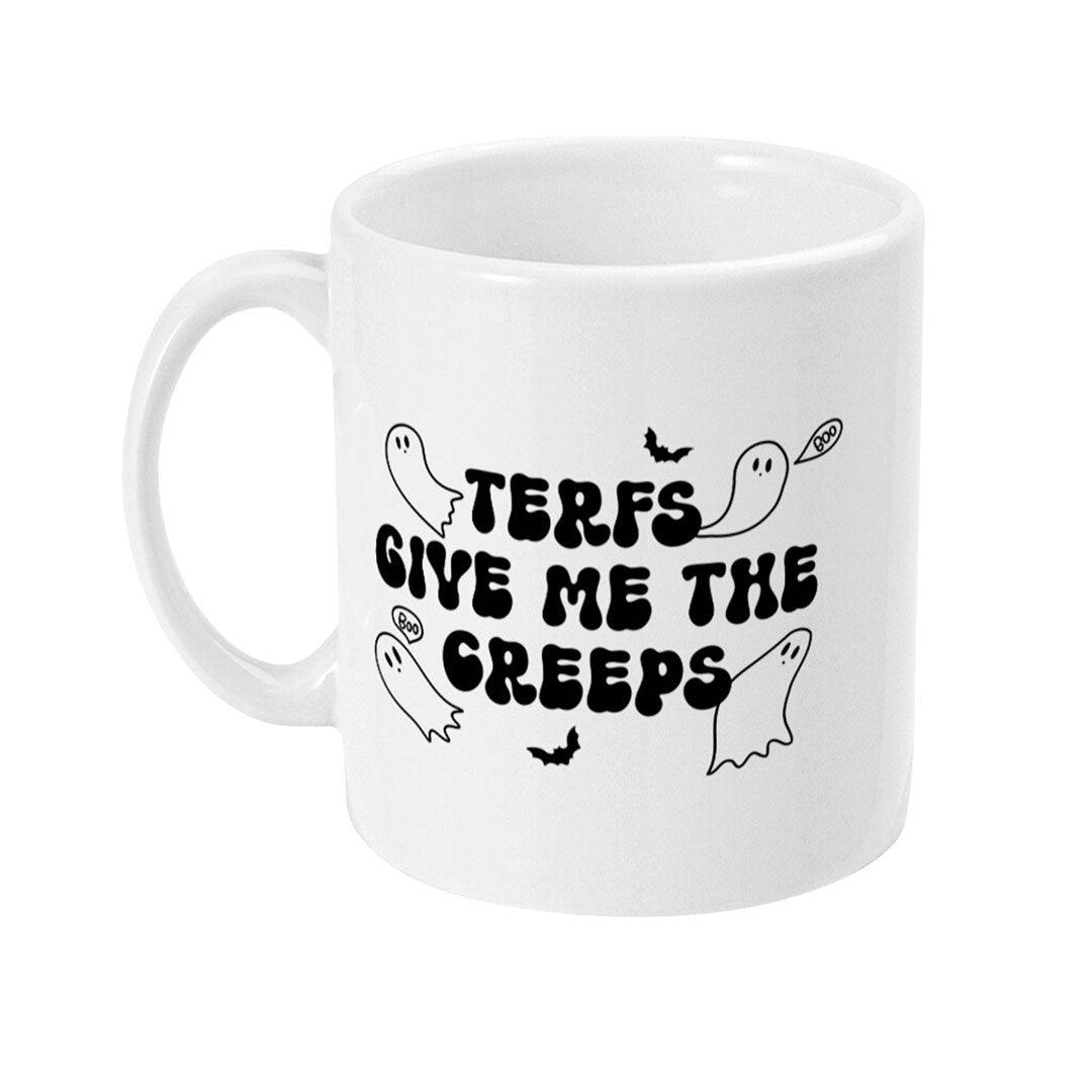 The left side of a white ceramic mug featuring a playful black and white design with small cartoon ghosts saying "boo." The text on the mug reads "TERFs Give Me The Creeps" in a bold, spooky font.