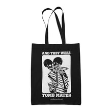 Load image into Gallery viewer, Black cotton tote bag featuring the slogan And They Were Tomb Mates alongside an image of two skeletons embracing