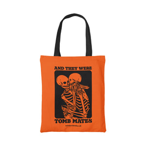 Orange cotton tote bag featuring the slogan And They Were Tomb Mates alongside an image of two skeletons embracing