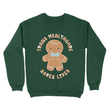 Load image into Gallery viewer, Bottle green sweatshirt featuring a gingerbread person with the phrase &#39;Trans Healthcare Saves Lives&#39; in festive lettering.