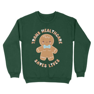 Bottle green sweatshirt featuring a gingerbread person with the phrase 'Trans Healthcare Saves Lives' in festive lettering.