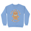Cornflower blue sweatshirt with a gingerbread person design and the text 'Trans Healthcare Saves Lives' in holiday-themed typography.